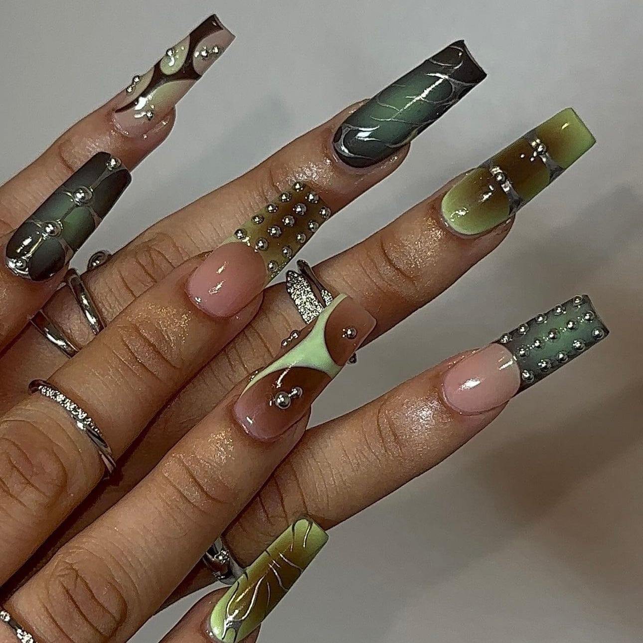 Green ombre nails showcasing a beautiful gradient of lush greens